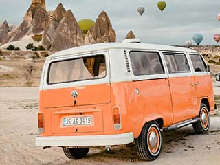 Orange minibus and hot air balloons.